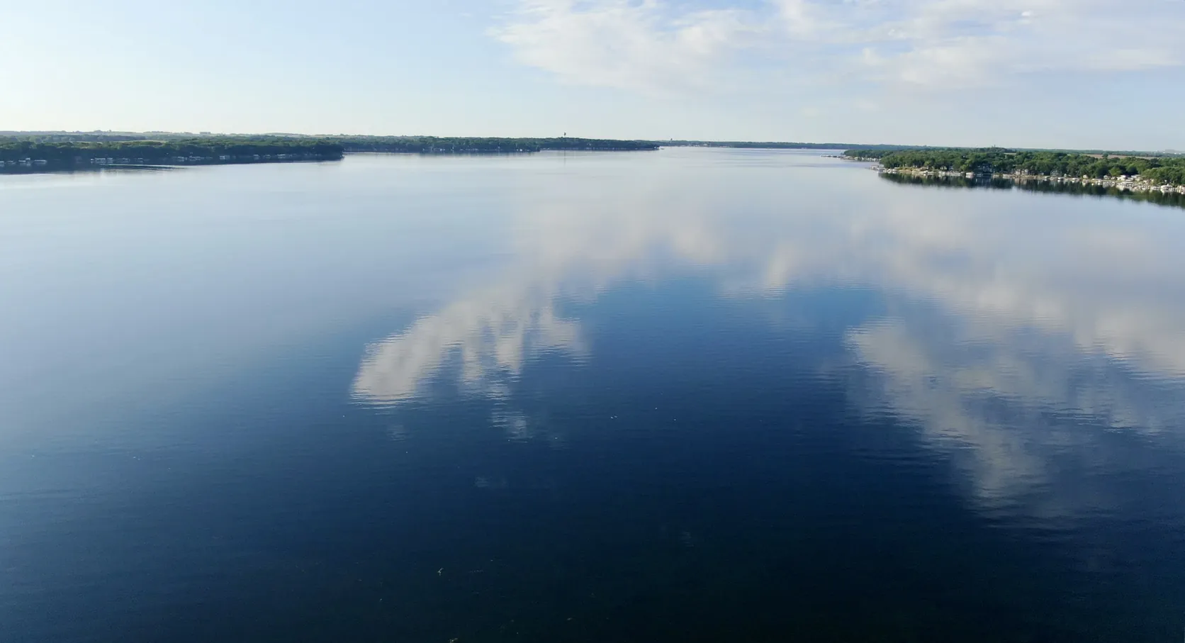 Calm water and reflected clouds on West Lake Okoboji, Iowa